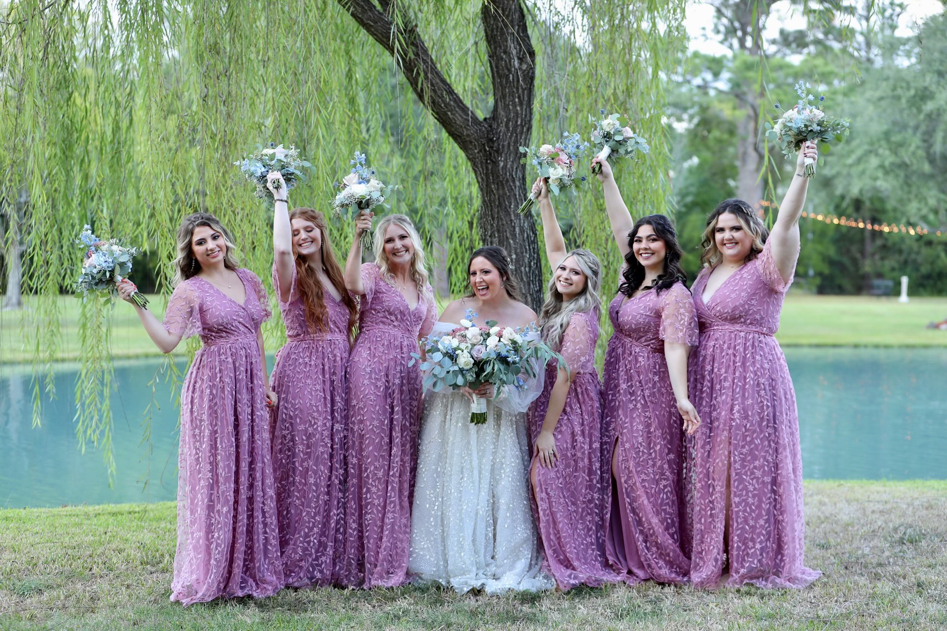 Rustic cedar wedding arbor with floral accents overlooking the water