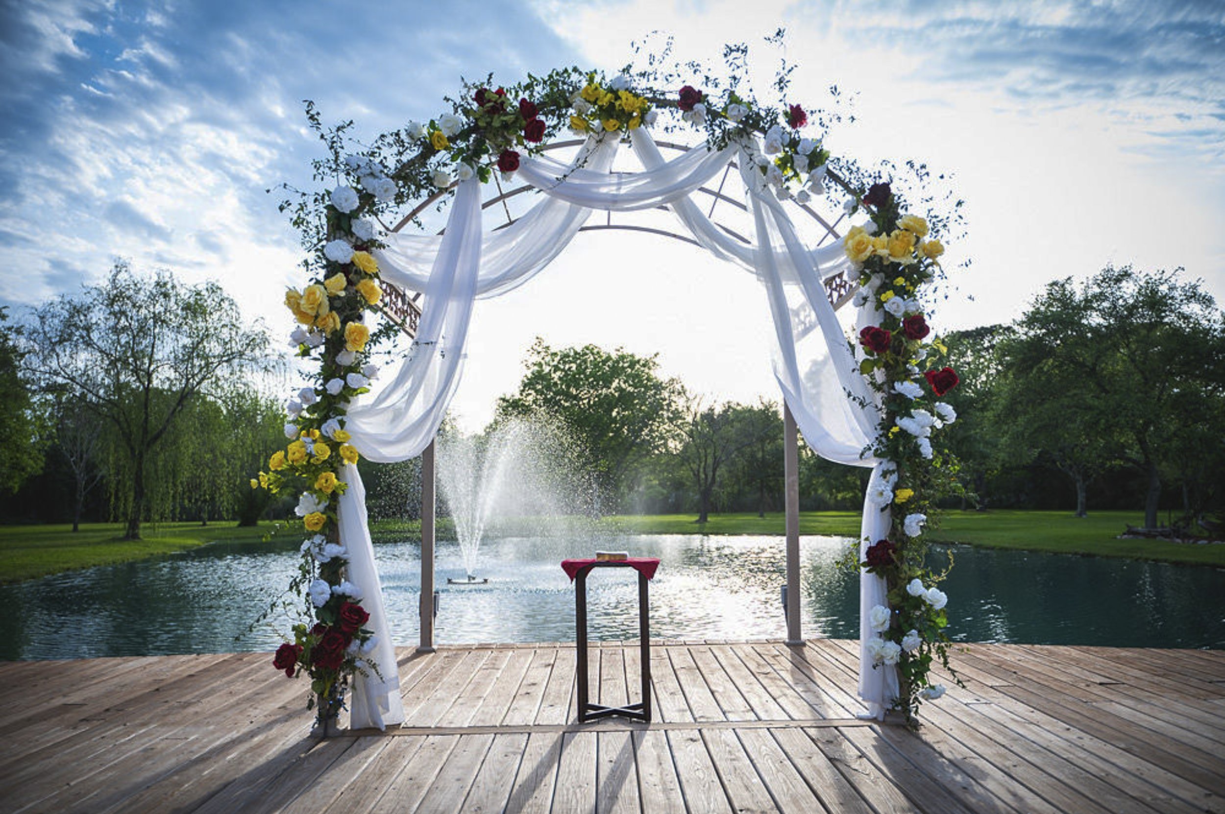 Lakeside gazebo illuminated with romantic garden lighting at dusk