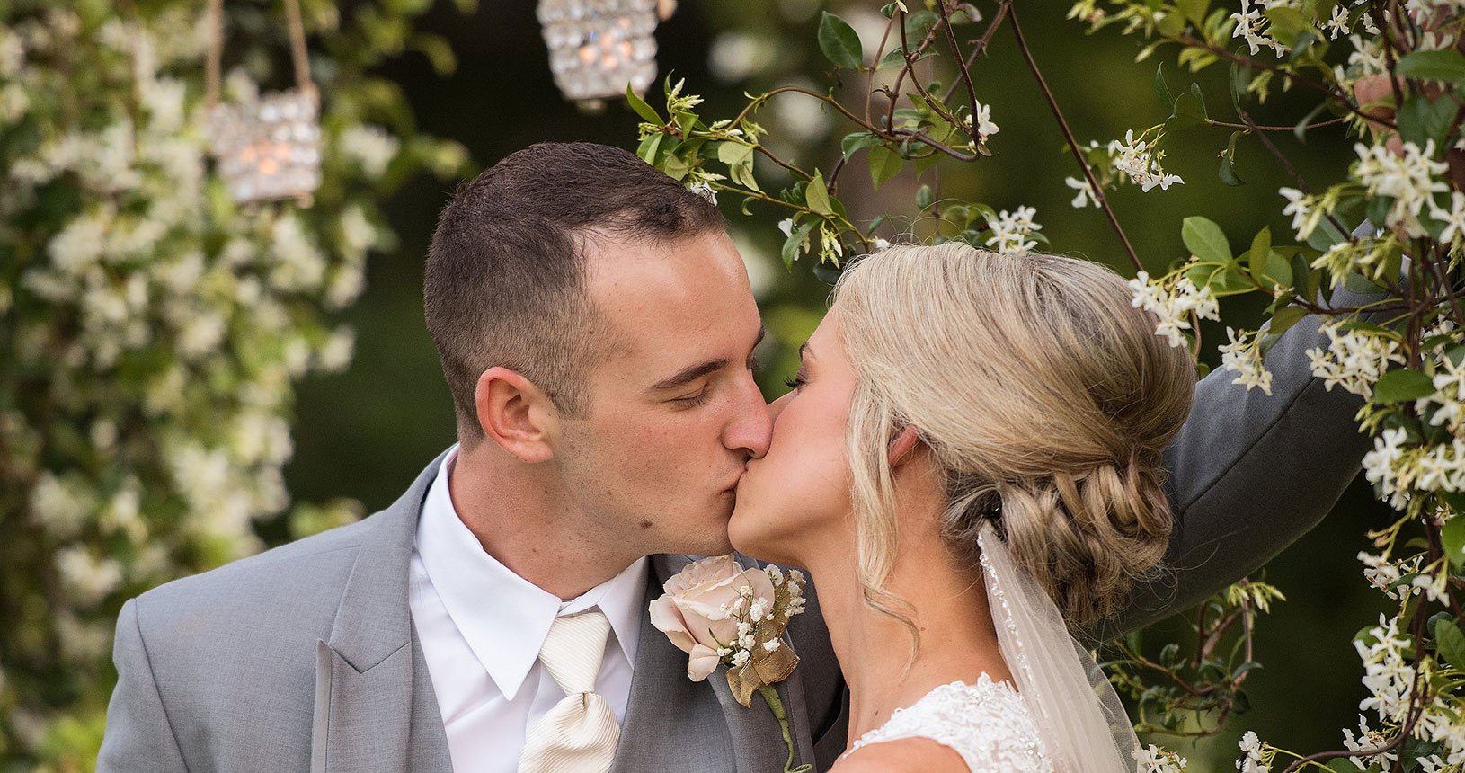 Romantic lakeside ceremony arbor with floral drapery at Kemah Gardens